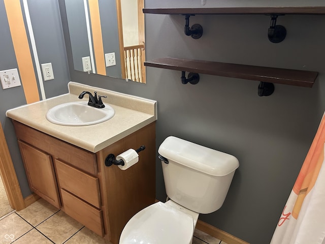 bathroom with toilet, tile patterned flooring, and vanity