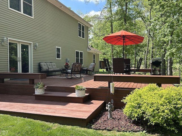 wooden deck with outdoor lounge area, french doors, and outdoor dining space