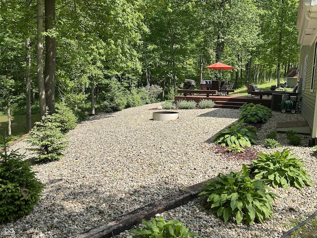 view of yard with a wooden deck and outdoor dining space