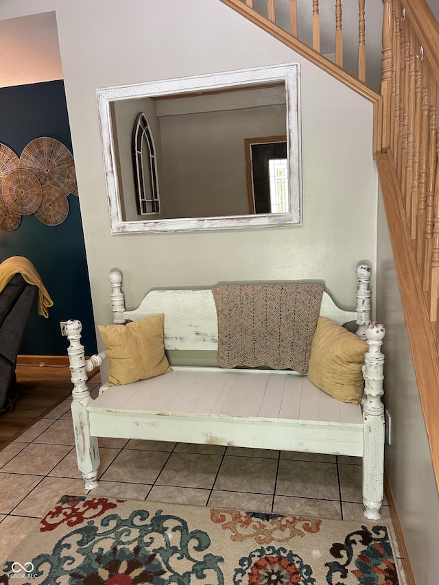 tiled living area featuring baseboards