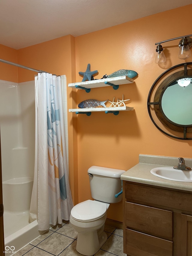 bathroom featuring tile patterned floors, a shower with shower curtain, toilet, and vanity