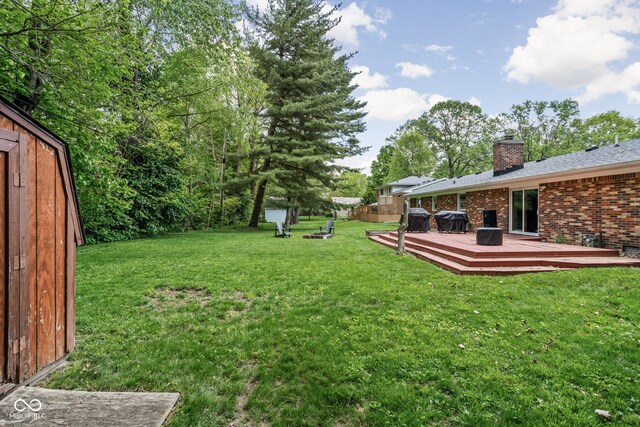 view of green lawn featuring a deck