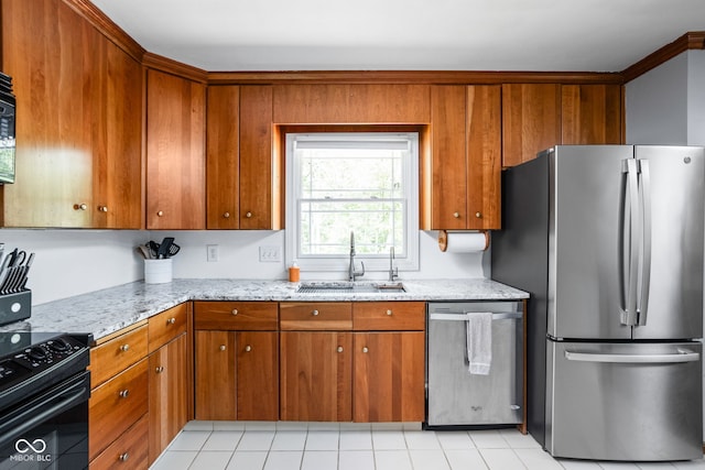 kitchen with appliances with stainless steel finishes, a sink, and brown cabinetry