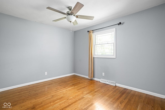 unfurnished room featuring baseboards, light wood-style floors, and ceiling fan