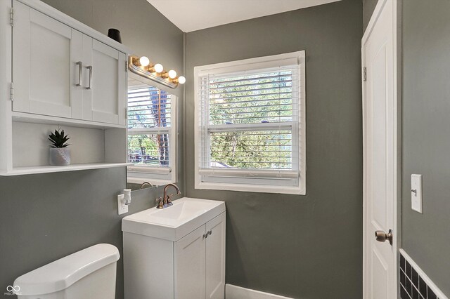 half bathroom with toilet and vanity