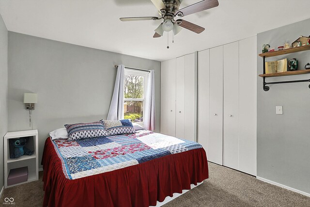 bedroom featuring carpet flooring, baseboards, a ceiling fan, and multiple closets