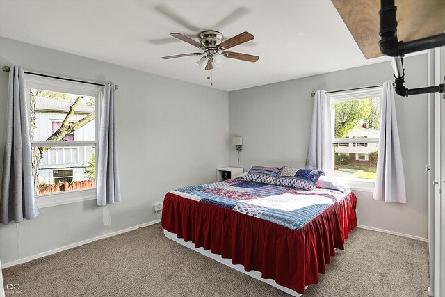 bedroom with carpet flooring, baseboards, and a ceiling fan