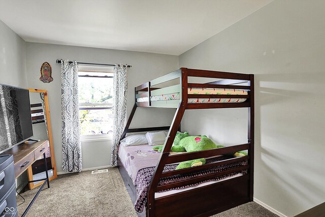 carpeted bedroom featuring baseboards