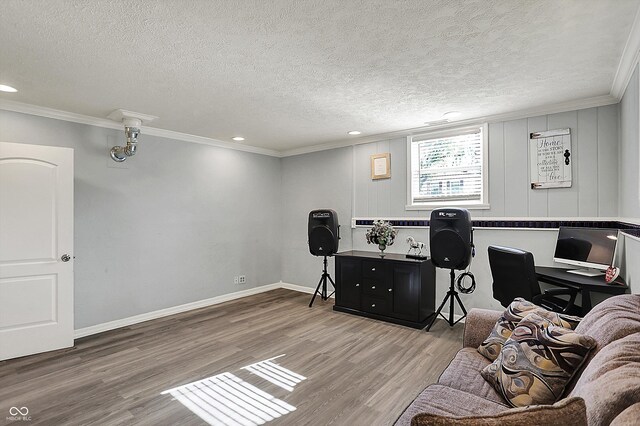 office featuring wood finished floors, a textured ceiling, recessed lighting, ornamental molding, and baseboards