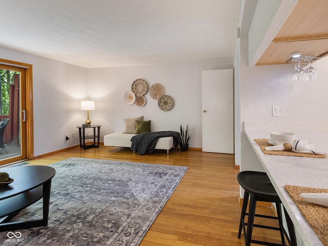 living room featuring light wood-style flooring and baseboards