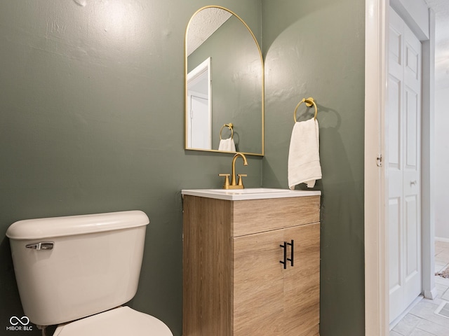 bathroom featuring toilet and vanity