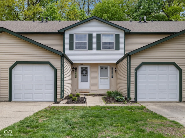 view of front of home featuring driveway, a garage, and a shingled roof