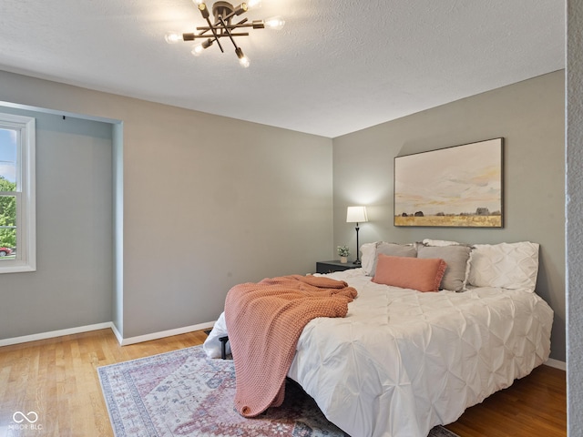 bedroom with wood finished floors and baseboards