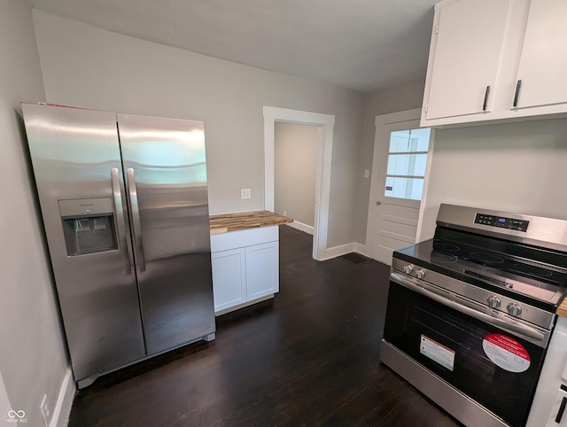 1009 Chestnut St, Anderson, IN 46012 - kitchen with appliances with stainless steel finishes, dark wood finished floors, white cabinetry, butcher block countertops, and baseboards