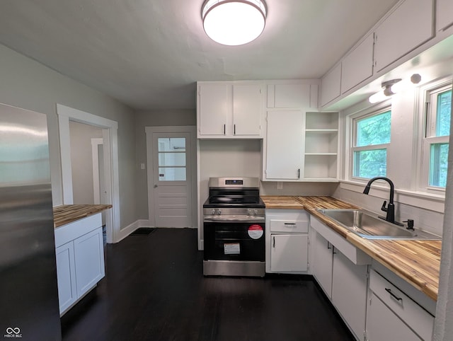 1009 Chestnut St, Anderson, IN 46012 - kitchen featuring stainless steel appliances, a sink, open shelves, white cabinetry, and dark wood-style flooring