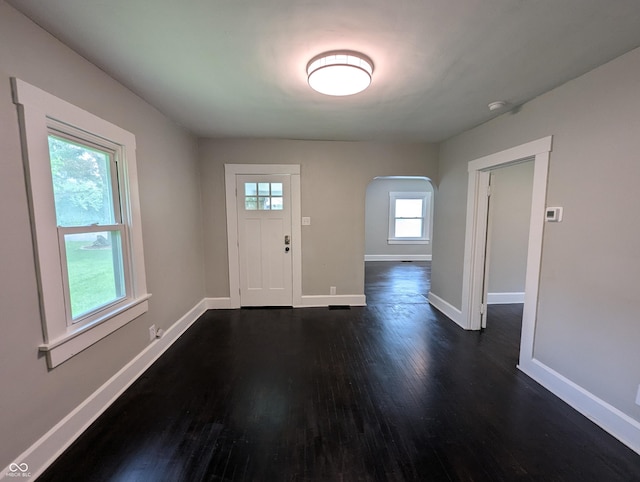 1009 Chestnut St, Anderson, IN 46012 - entryway with arched walkways, dark wood-style floors, and baseboards