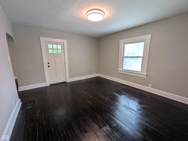 1009 Chestnut St, Anderson, IN 46012 - entryway with dark wood-style floors, baseboards, and arched walkways