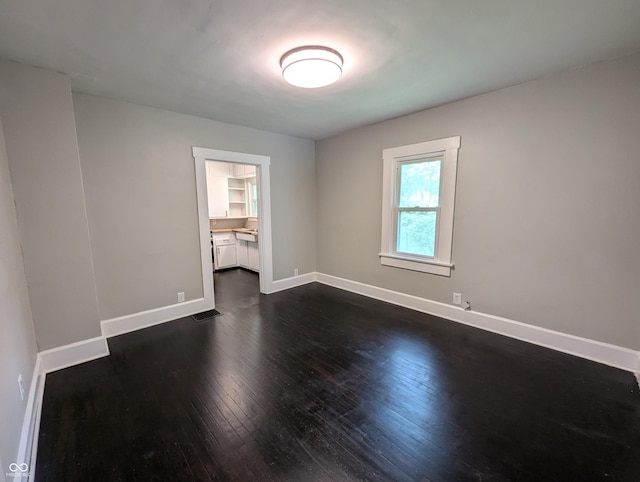 1009 Chestnut St, Anderson, IN 46012 - unfurnished room featuring dark wood finished floors and baseboards