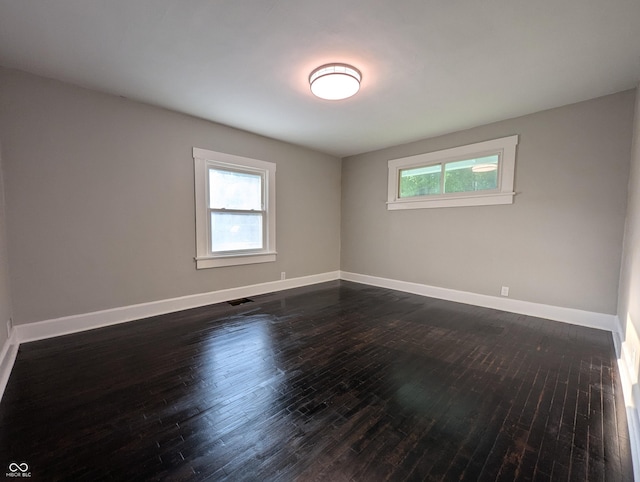1009 Chestnut St, Anderson, IN 46012 - unfurnished room featuring baseboards and dark wood-type flooring