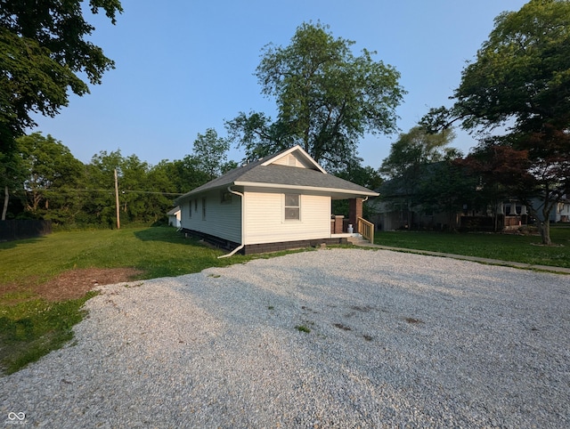 1009 Chestnut St, Anderson, IN 46012 - view of home's exterior featuring driveway, a lawn, and a shingled roof