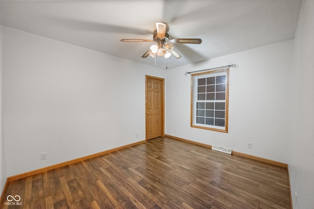 spare room featuring wood finished floors, baseboards, and a ceiling fan