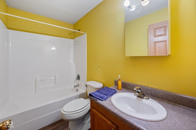 bathroom with toilet, vanity,  shower combination, and wood finished floors