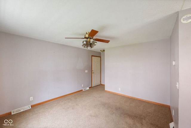 unfurnished room with a ceiling fan, light carpet, and baseboards
