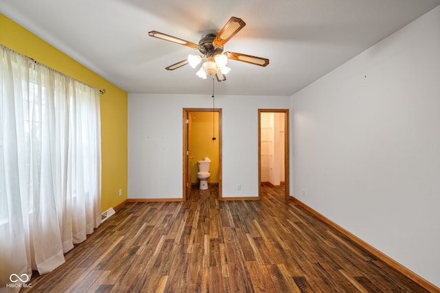 spare room with wood finished floors, baseboards, and a ceiling fan