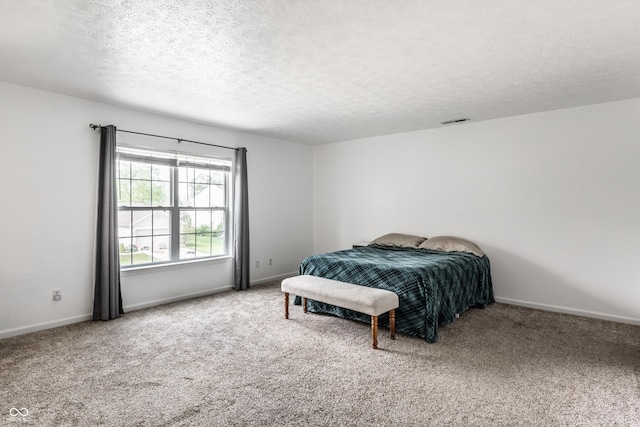 bedroom with carpet floors, a textured ceiling, and baseboards