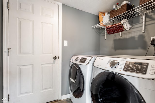 laundry area featuring washing machine and clothes dryer