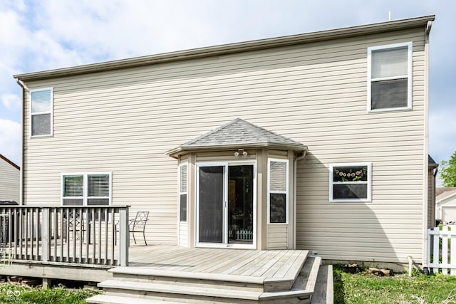 rear view of property featuring a deck