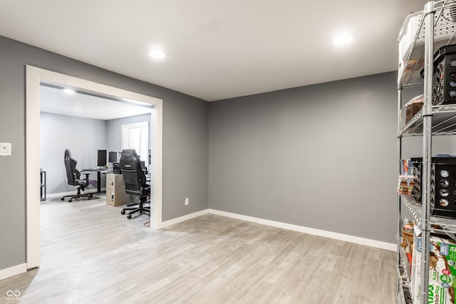 office with light wood-type flooring, baseboards, and recessed lighting