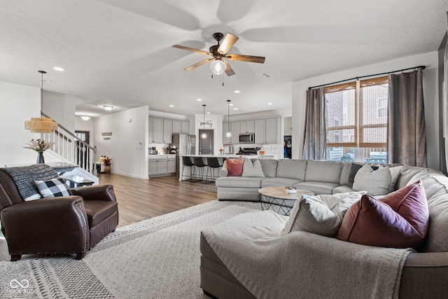 1289 Sunset Blvd, Avon, IN 46123 - living area with stairs, light wood finished floors, a ceiling fan, and recessed lighting