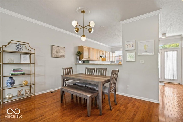 2405 N Park Ave, Indianapolis, IN 46205 - dining area featuring a textured ceiling, hardwood / wood-style flooring, baseboards, a chandelier, and crown molding