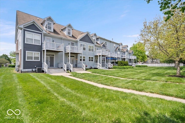 2405 N Park Ave, Indianapolis, IN 46205 - rear view of house featuring a balcony, central AC unit, a lawn, and a residential view