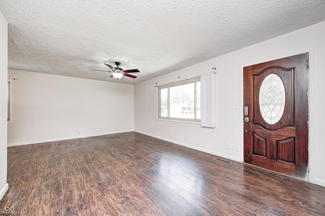 foyer entrance featuring wood finished floors, a ceiling fan, a textured ceiling, and baseboards
