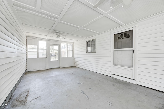 unfurnished sunroom with ceiling fan