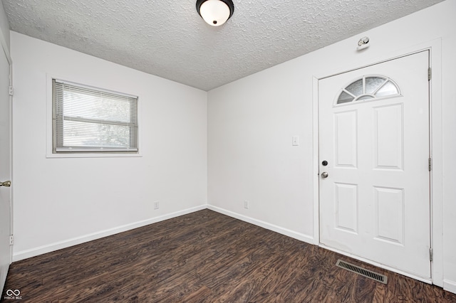 entrance foyer featuring wood finished floors, a textured ceiling, and baseboards