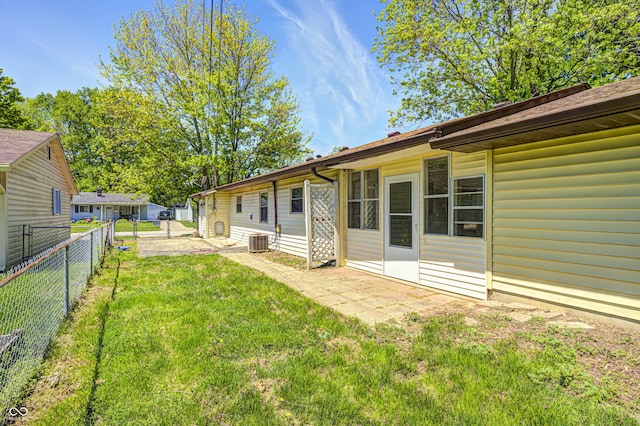 view of yard featuring central air condition unit and a patio
