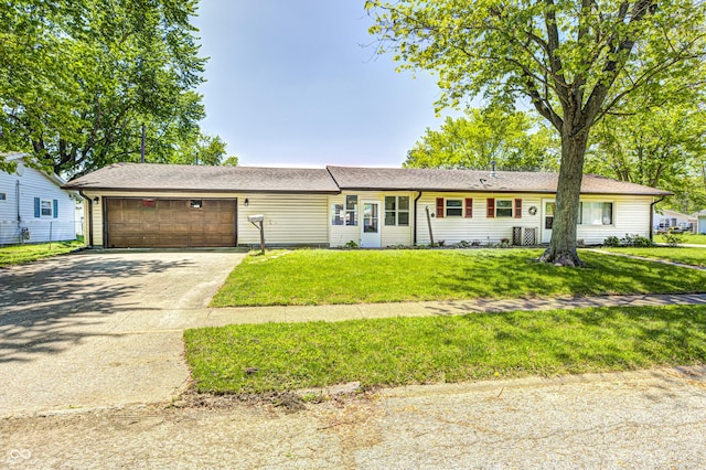 ranch-style home featuring an attached garage, concrete driveway, and a front yard