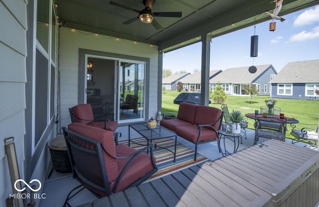 wooden deck featuring ceiling fan, outdoor lounge area, a yard, and a residential view