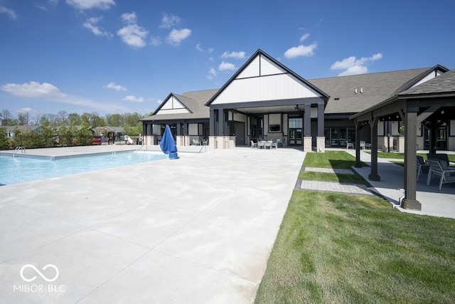 rear view of house with a patio and a community pool