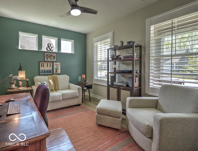 living room with ceiling fan, wood finished floors, and baseboards