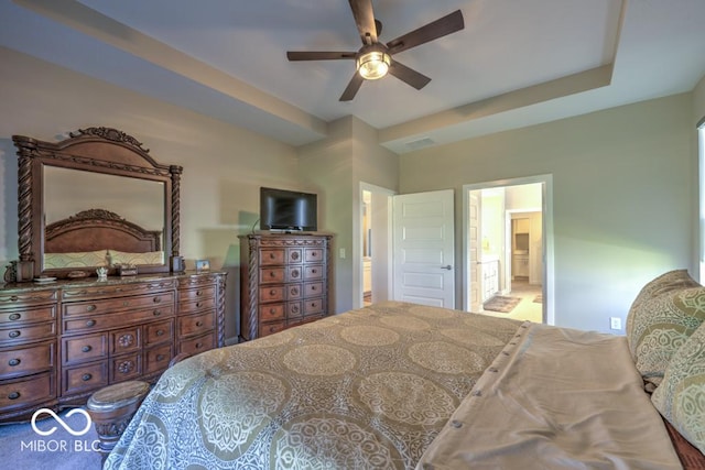 bedroom with connected bathroom and a ceiling fan