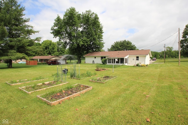2237 W 100 N, Greenfield, IN 46140 - view of green lawn featuring a vegetable garden and a carport