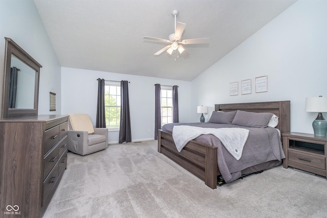 bedroom featuring vaulted ceiling, light colored carpet, baseboards, and a ceiling fan