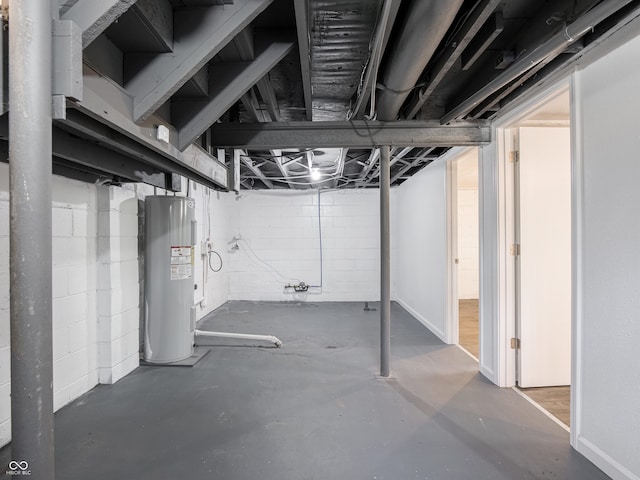 unfinished basement with electric water heater and concrete block wall