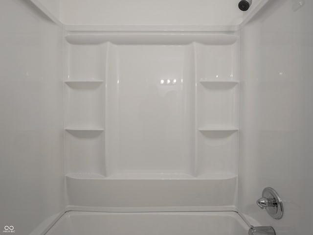 bathroom view of washtub / shower combination