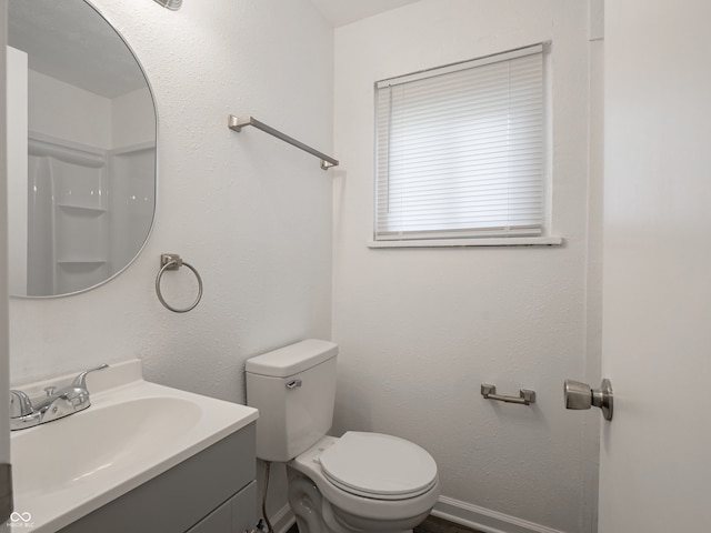 bathroom featuring toilet and vanity