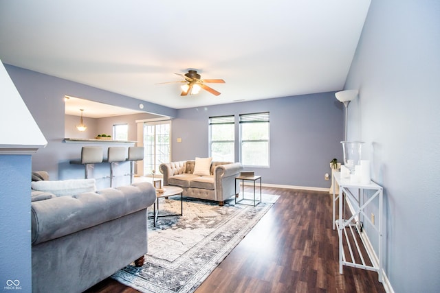 1404 Norton Dr, Greenwood, IN 46143 - living area featuring wood finished floors, a ceiling fan, and baseboards